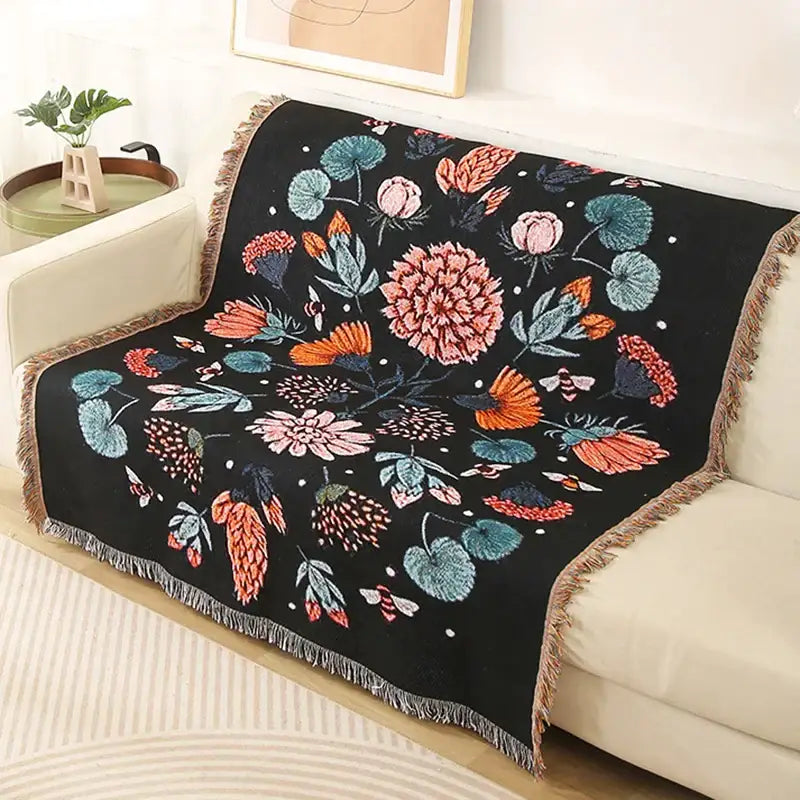 Black throw blanket with vibrant floral and butterfly patterns in pink orange teal and white fringed edges decorbites leopard print throw