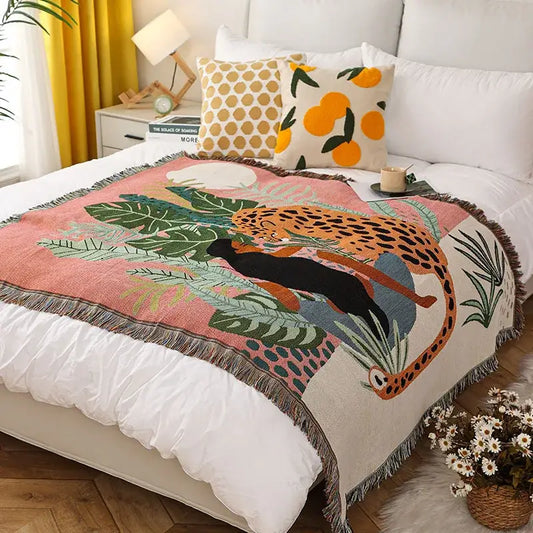 Cozy pink and cream leopard print throw blanket with vibrant jungle scene and fringed edges for bedroom decorbites decor