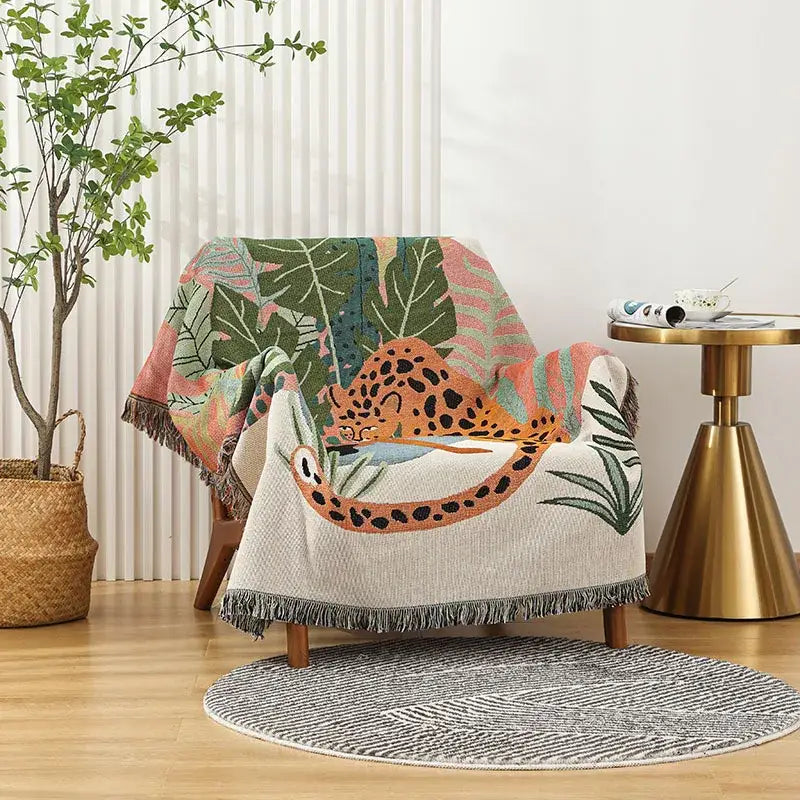 Cozy woven print throw blanket featuring a decorbites leopard print with jungle pink cream and green foliage design