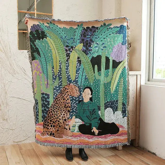 A vibrant jungle pink and cream leopard print throw blanket with a woman and leopard design and fringed edges decorbites leopard print