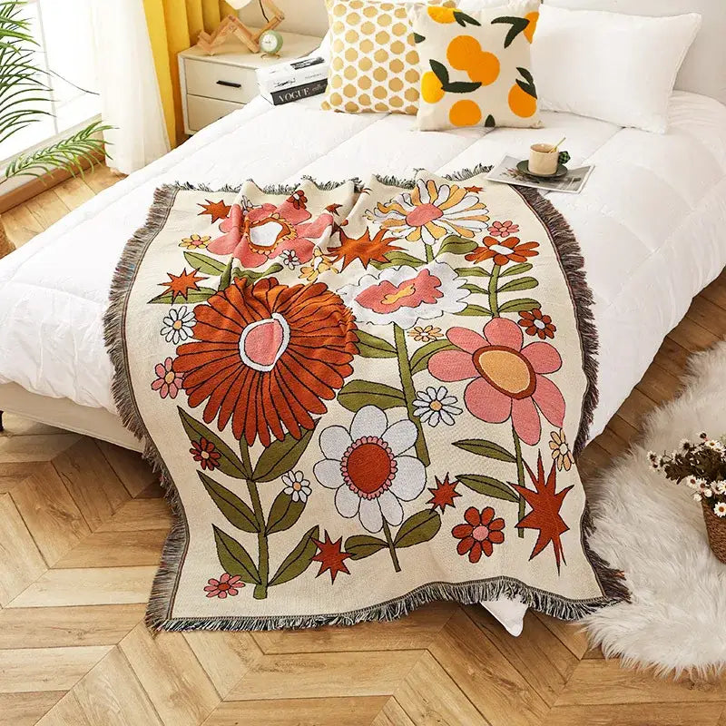 A cream woven print throw blanket with vibrant orange pink floral pattern and jungle pink cream leopard print decorbites design