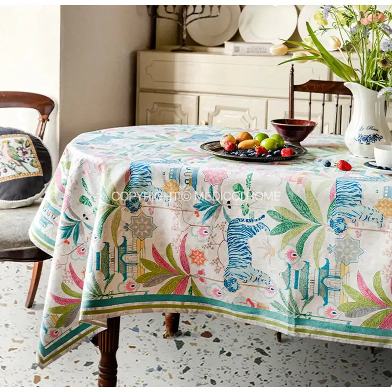 Decorbites jungle vibes tablecloth in cream with blue green tiger print and tropical motifs for kitchen decor