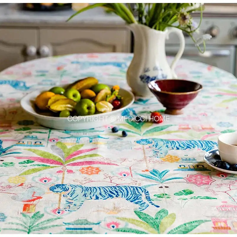 Jungle vibes tablecloth by decorbites features blue tigers and tropical foliage in cream, green, and pink decor