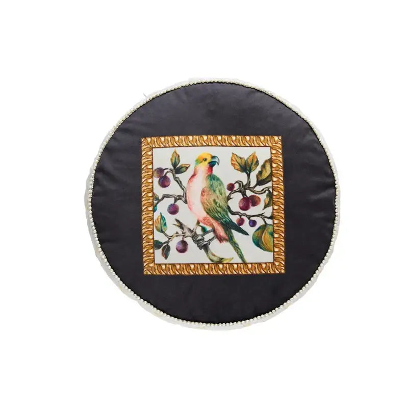 Black circular cushion with colorful parrot print and white fringe for decorbites jungle vibes tablecloth decorbites jungle