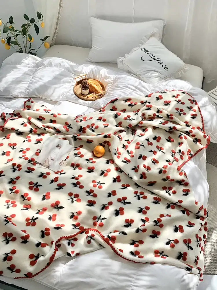 A cozy cream kids wool blanket with red and black decorbites 3d cherry pattern perfect for bedroom decor