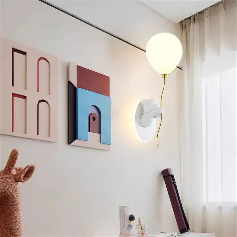Modern white wall light with a spherical glowing lampshade and gold stem for kawaii decorbites bear balloon design