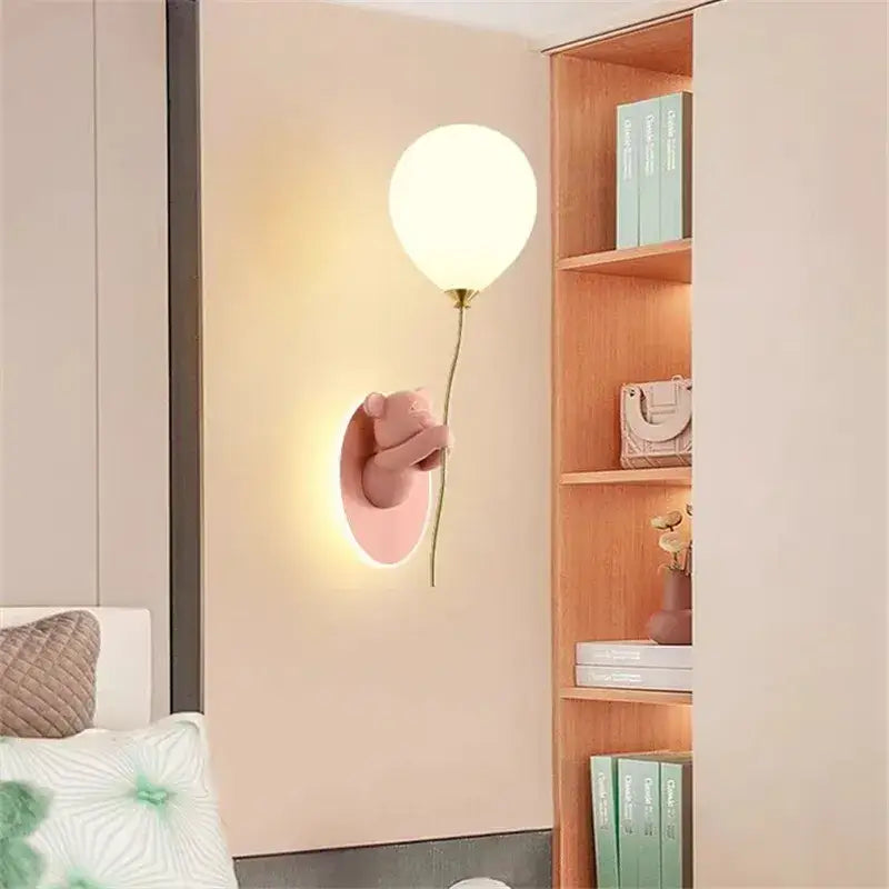 Pastel pink bear balloon wall light holding a glowing white balloon by decorbites for children bedroom decor