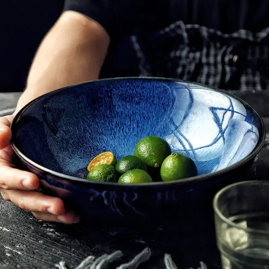 Deep blue kiln glazed ceramic bowl with speckled texture and white brushstroke patterns for dining room use