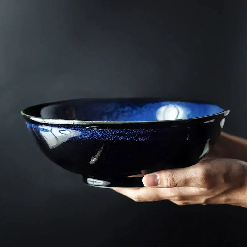 A kiln glazed ceramic deep blue speckled bowl held in hand ideal for dining room ramen by decorbites kiln glazed