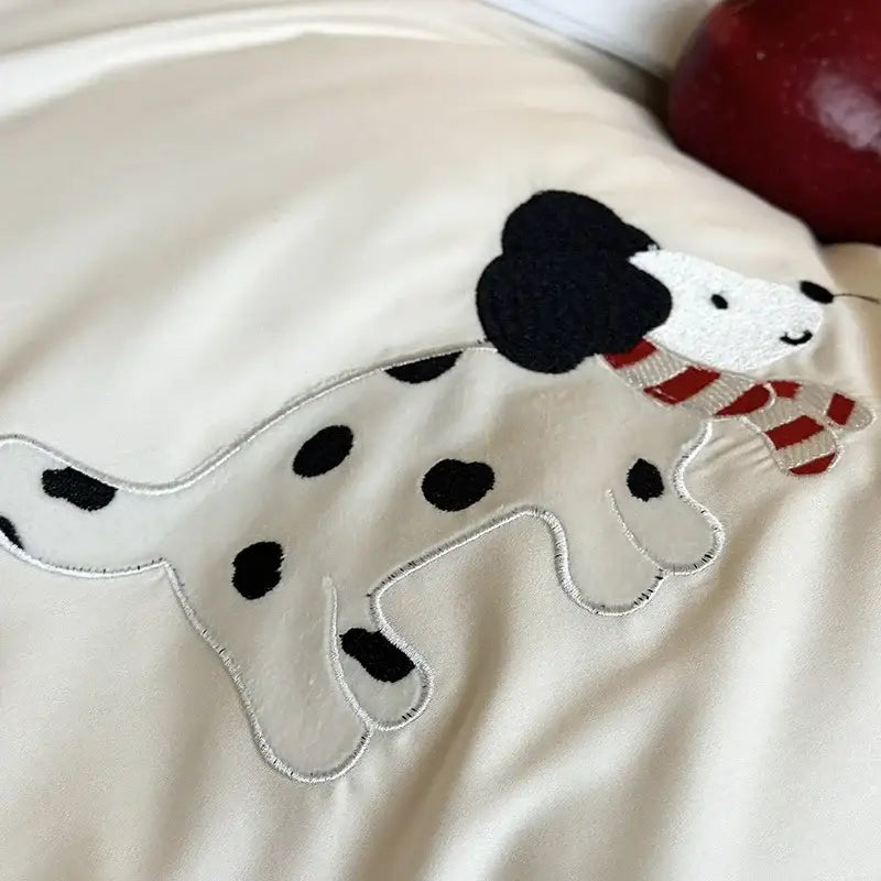 Cream-colored pillow with embroidered dalmatian wearing red-and-white scarf in king bear embroidered bedding set by decorbites