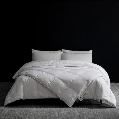 White quilted king size goose down and silk duvet set with plush texture and subtle stitching for master bedroom luxury