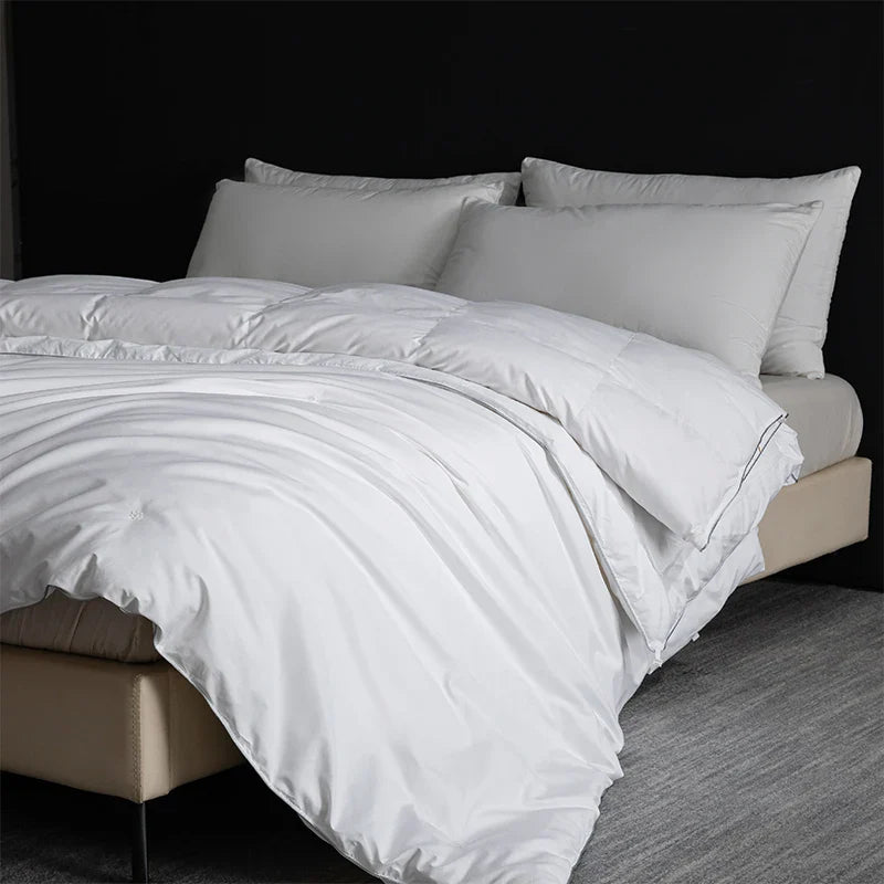 King size white quilted goose down and silk duvet set with satin finish and subtle stitching for luxury bedroom use