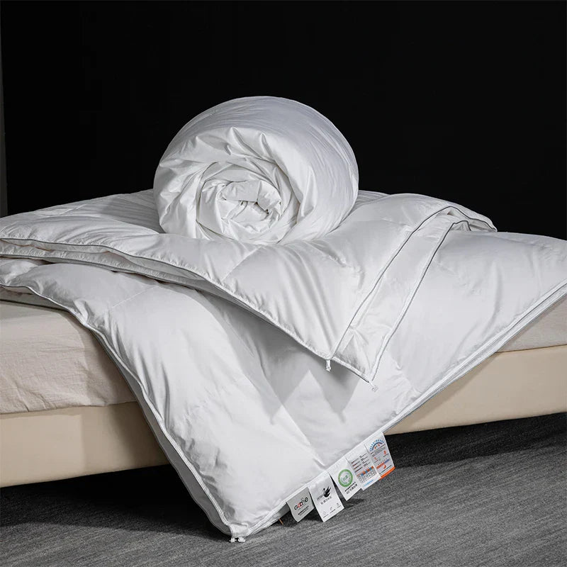 King size white quilted goose down and silk comforter with plush texture and subtle stitching for master bedroom luxury