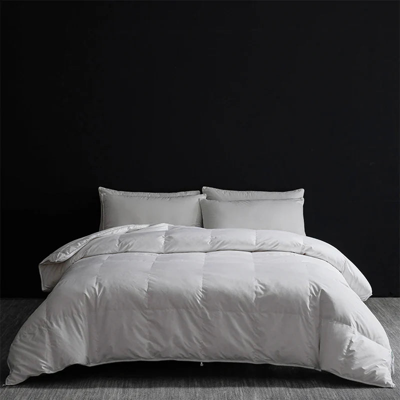 White quilted king size goose down and silk duvet set with soft plush texture and subtle sheen for luxury master bedroom