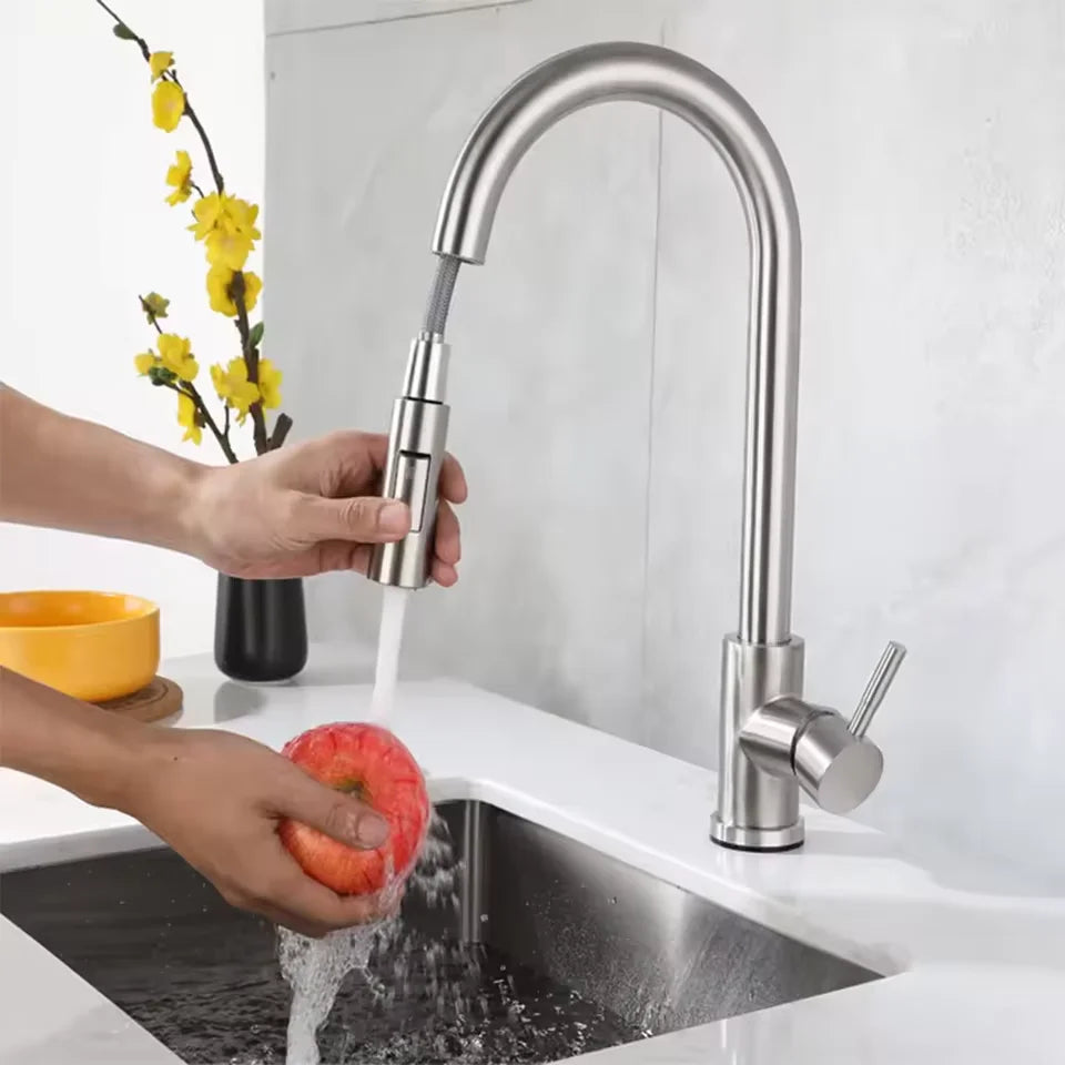 Stainless steel single hole kitchen faucet with a sleek curved spout and pull-down spray head in brushed nickel and black