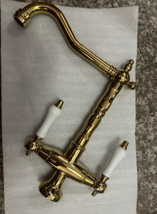 Brass kitchen faucet with white ceramic handles and vintage design for single hole installation and 360 degree swivel