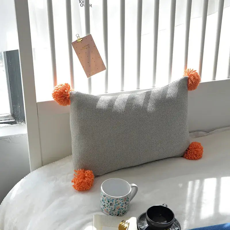 Gray textured knit cushion cover with bright orange pom-poms for living room decorbites knit cushion set