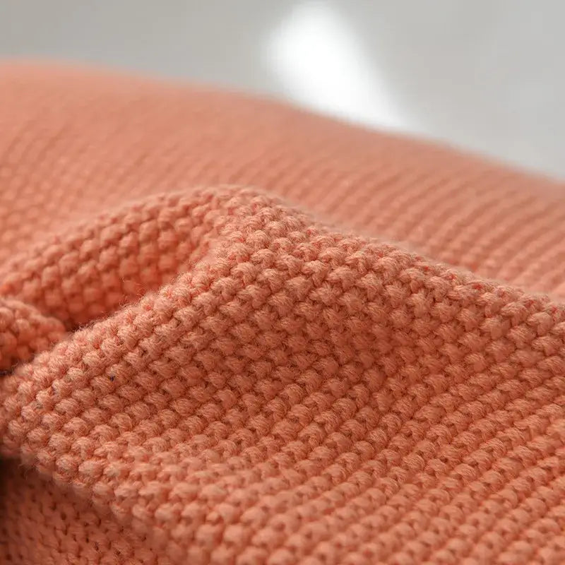 Soft peach-colored knitted fabric with ribbed pattern on decorbites knit cushion cover for blue orange grey living room decor