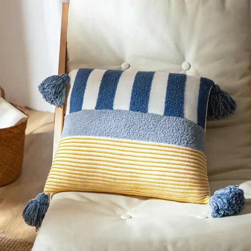 A cozy knit stripe pillow cover featuring navy and white stripes, gray band, yellow texture, and blue tassels for decorbites knit stripe decor