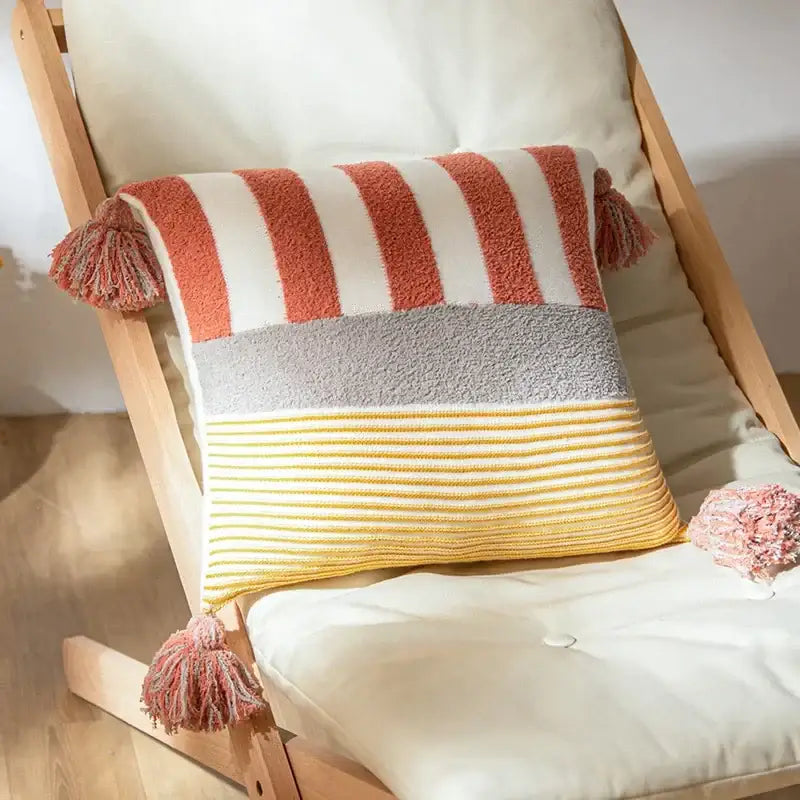 A cozy coral and white knit stripe pillow cover with horizontal stripes and tassels for living room decorbites knit stripe decor