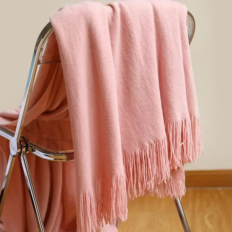 A soft pink knitted cashmere siesta blanket with delicate fringe edges perfect for bedroom decorbites decor