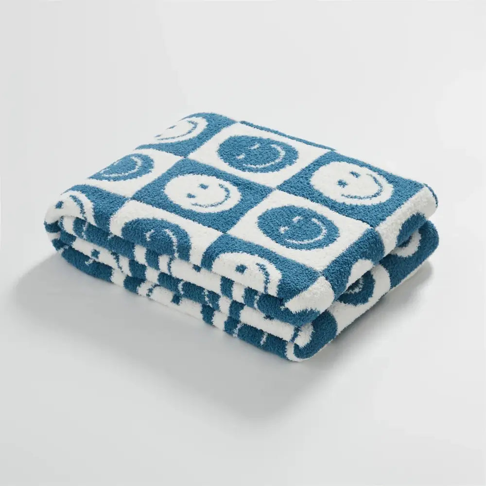 A decorbites knitted checkboard gray and white bedroom throw blanket with blue and white checkboard smile face pattern