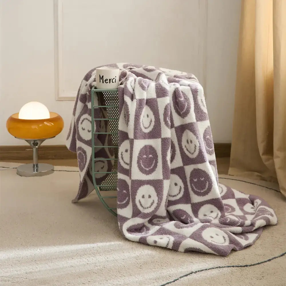 Decorbites knitted checkboard smile face throw blanket in purple and white with playful checkerboard pattern for bedroom decor