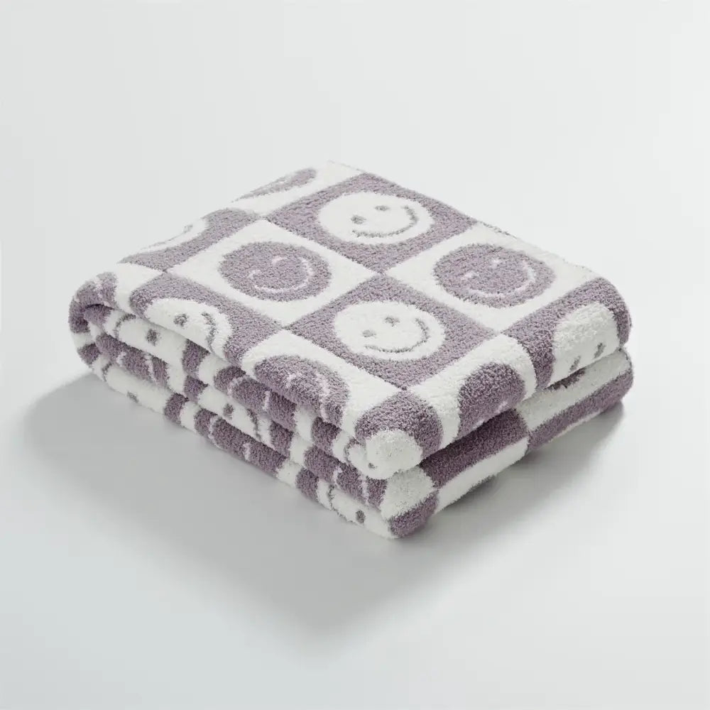 A soft plush knitted checkboard smile face gray and white blanket throw with playful smiling faces decorbites knitted checkboard