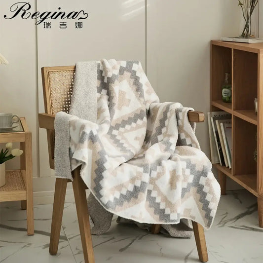 Soft cream and gray knitted geometric quilt blanket terry cloth throw draped over wooden chair decorbites knitted geometric