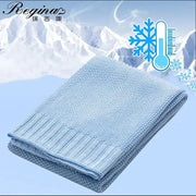 Knitted light blue bamboo baby blanket with textured breathable weave and ribbed edges for nursery use