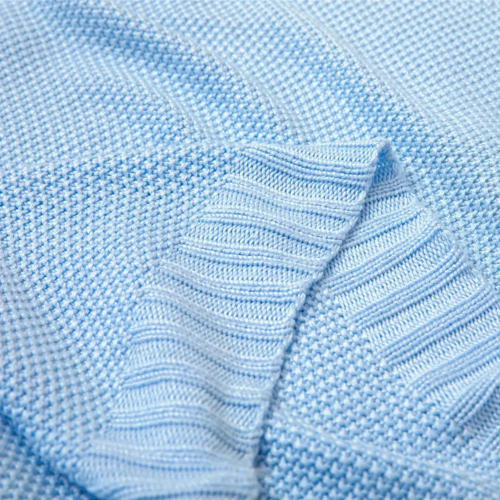 Light blue knitted sweater with ribbed texture made from breathable bamboo baby blanket fabric for nursery use