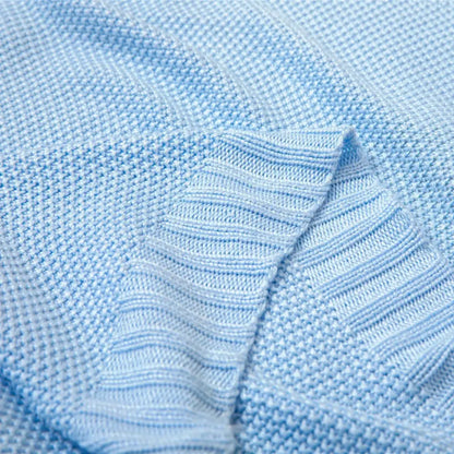 Light blue knitted sweater with ribbed texture made from breathable bamboo baby blanket fabric for nursery use