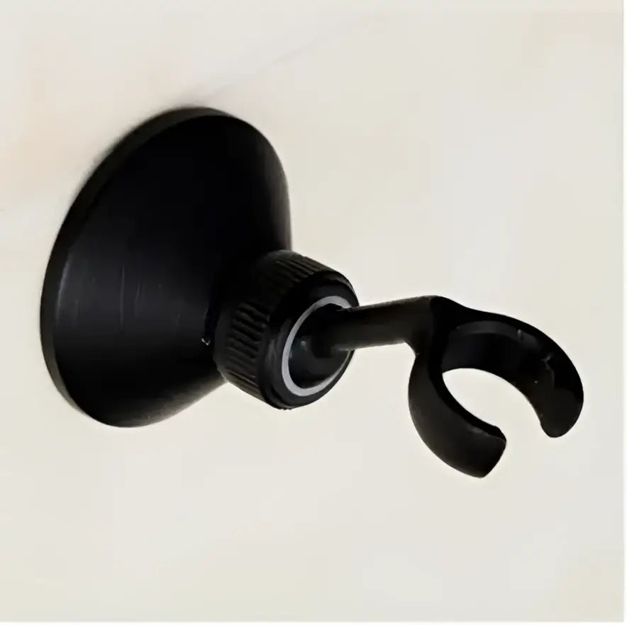Black matte-finished suction cup shower head holder with curved hook for secure bathroom mounting