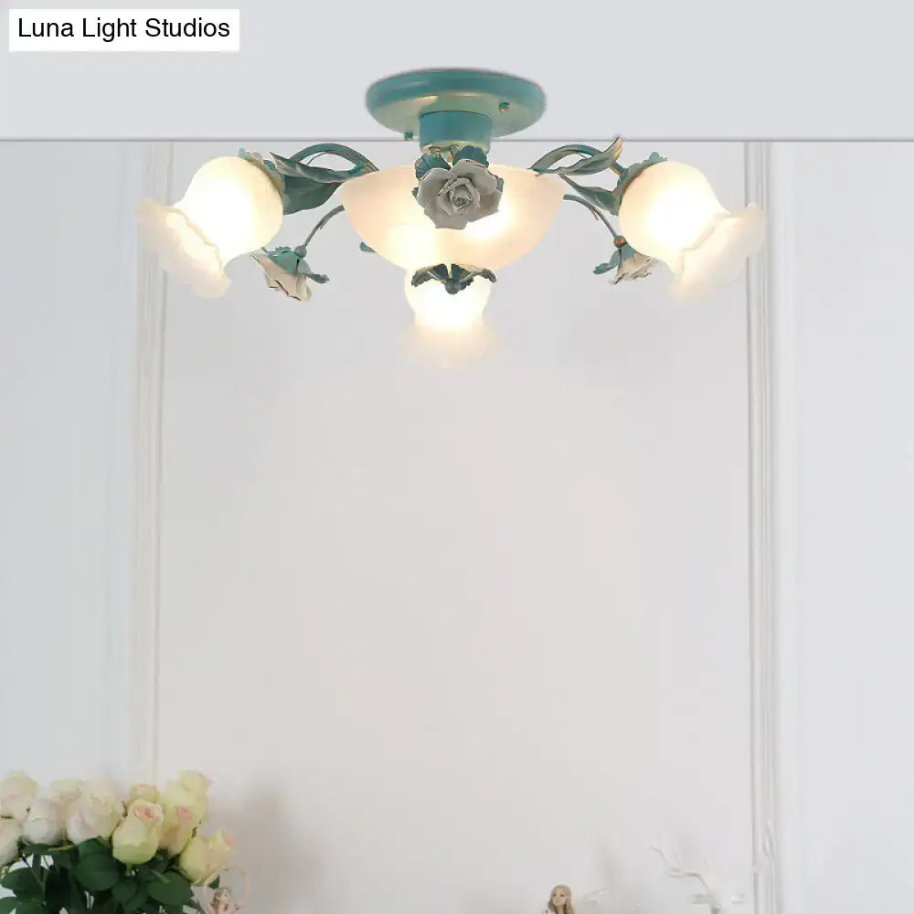 A teal korean garden flower ceiling light fixture with ornate floral design and frosted glass shades for bedroom