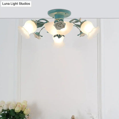 A teal korean garden flower ceiling light fixture with ornate floral design and frosted glass shades for bedroom