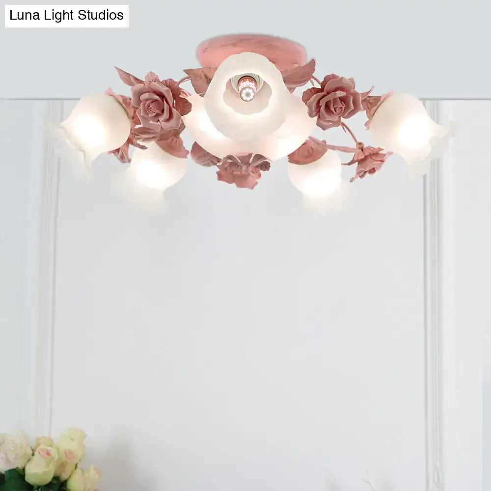 A delicate pink korean garden flower ceiling light fixture with frosted glass petals and metallic floral accents