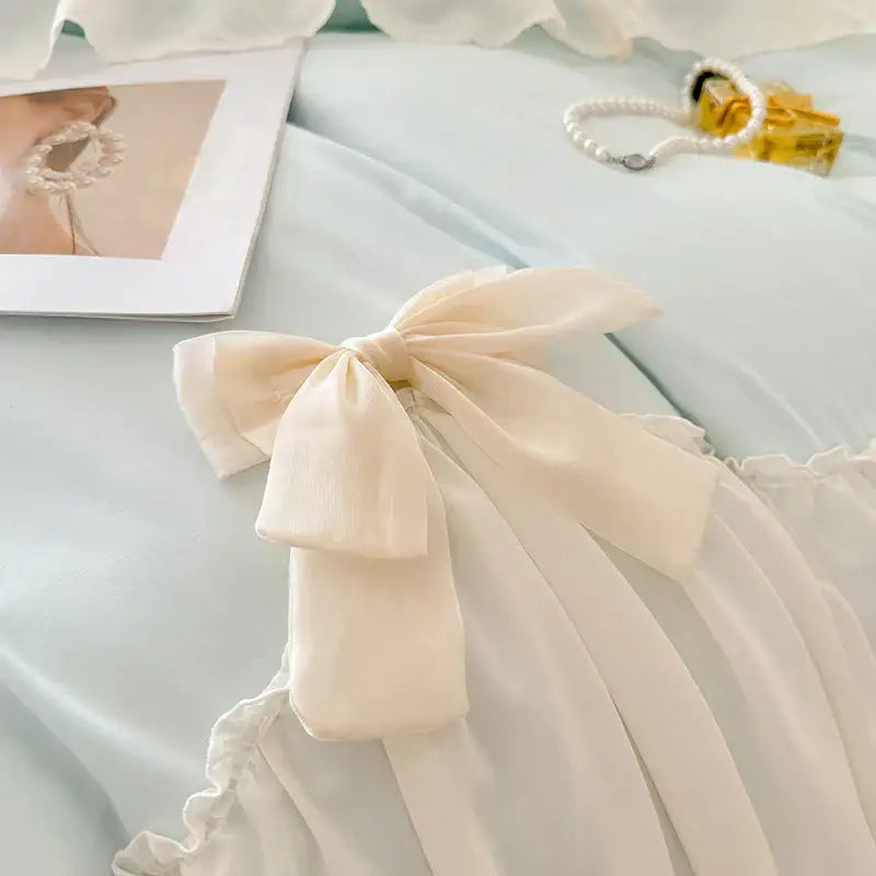 Cream-colored satin korean lace bow on blue and cream bedding set for elegant decorbites korean lace bedroom decor
