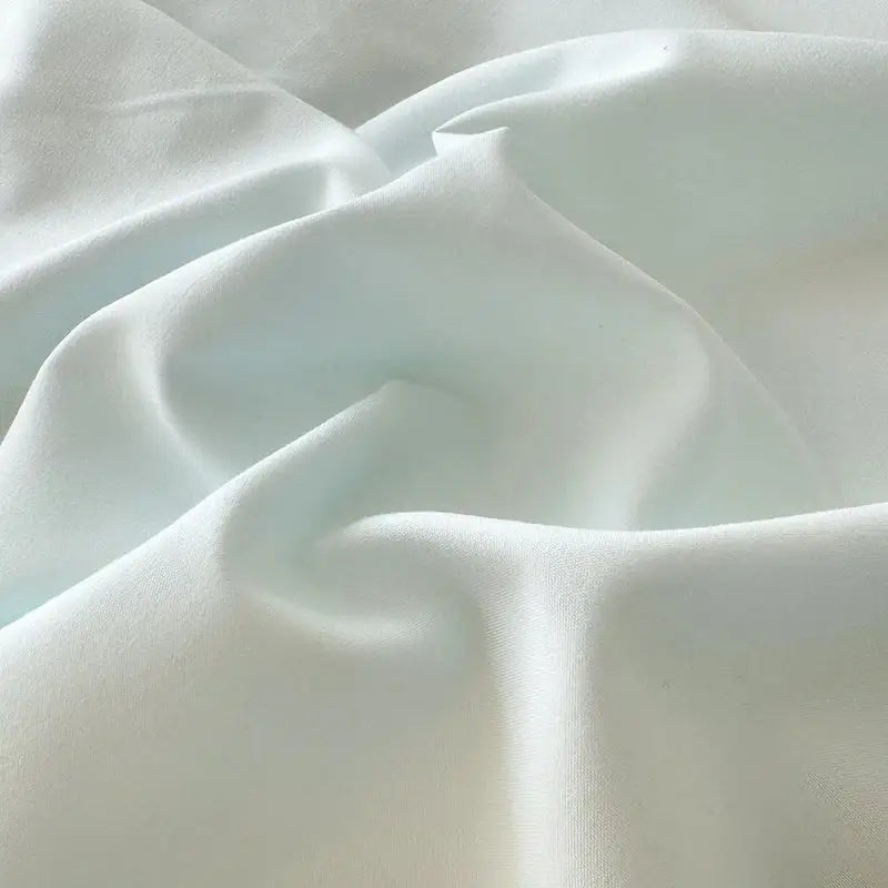Soft pale mint-green silk fabric with gentle folds in decorbites korean lace bow bedding set for elegant bedroom decor
