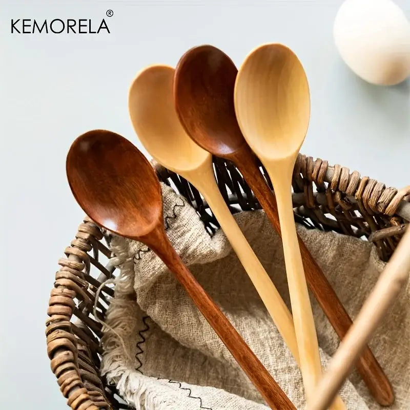Set of five handcrafted wooden spoon set in natural and dark brown tones displayed in a woven basket for dining room