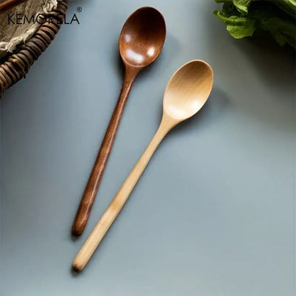 Two wooden spoons in natural light wood and dark brown finish from a Korean style wooden spoon set for dining room use