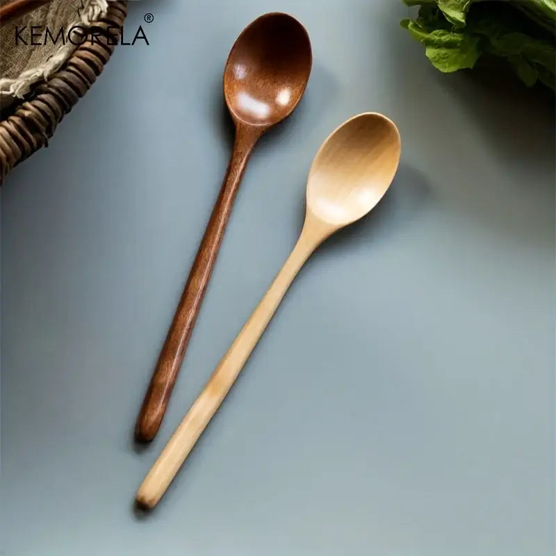 Two wooden spoons in natural light wood and dark brown finish from a Korean style wooden spoon set for dining room use