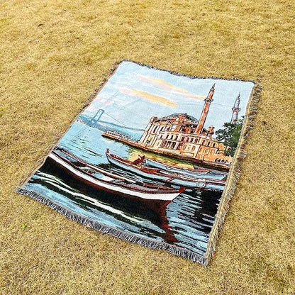 A rectangular woven decorbites jacquard sofa blanket featuring vibrant boats and mosque landscape for living room decor