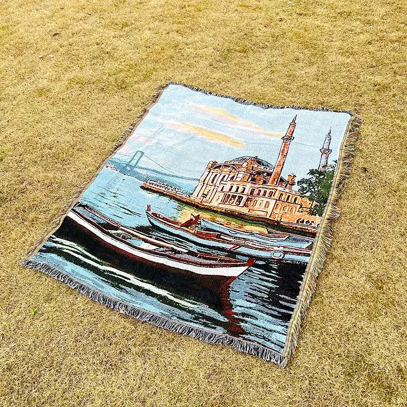A rectangular woven decorbites jacquard sofa blanket featuring vibrant boats and mosque landscape for living room decor