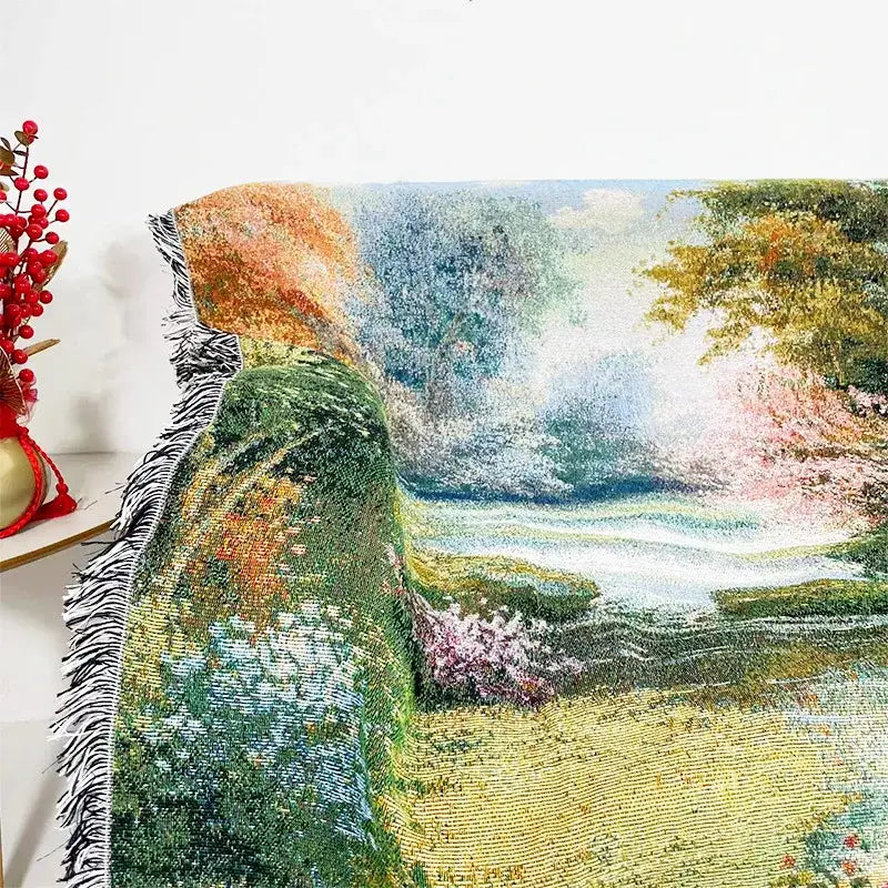 Decorbites jacquard sofa blanket featuring a vibrant woven tapestry landscape with green hills and blooming trees