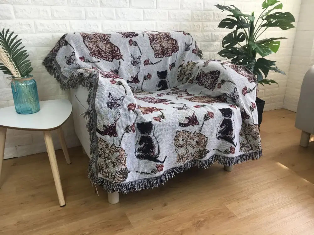 White woven decorbites jacquard sofa blanket with embroidered cat and floral patterns and fringed edges