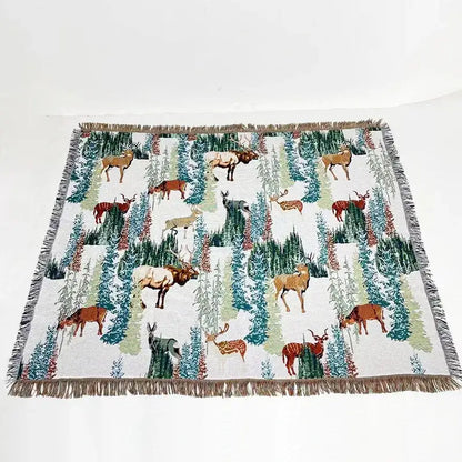 White woven decorbites jacquard sofa blanket with deer and evergreen pattern and fringed edges for living room decor