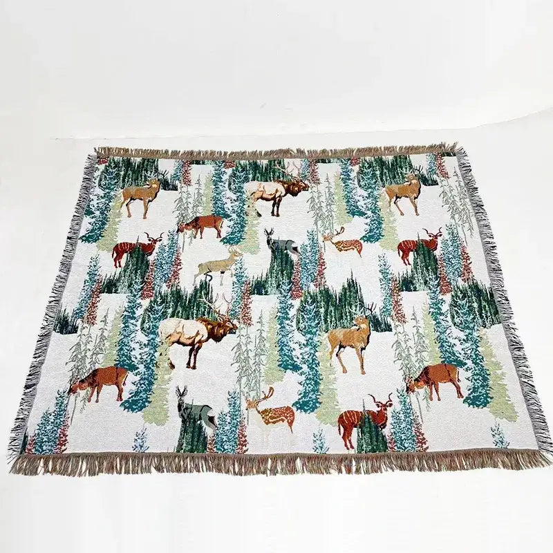 White woven decorbites jacquard sofa blanket with deer and evergreen pattern and fringed edges for living room decor