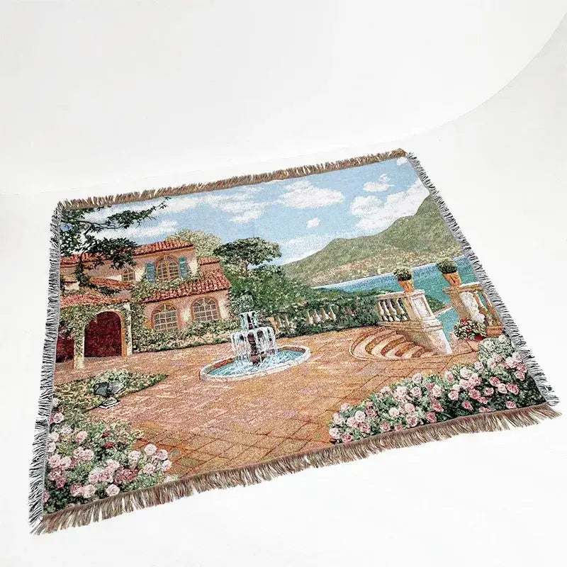 A decorbites jacquard sofa blanket featuring a woven mediterranean courtyard with terracotta roofs and pink roses