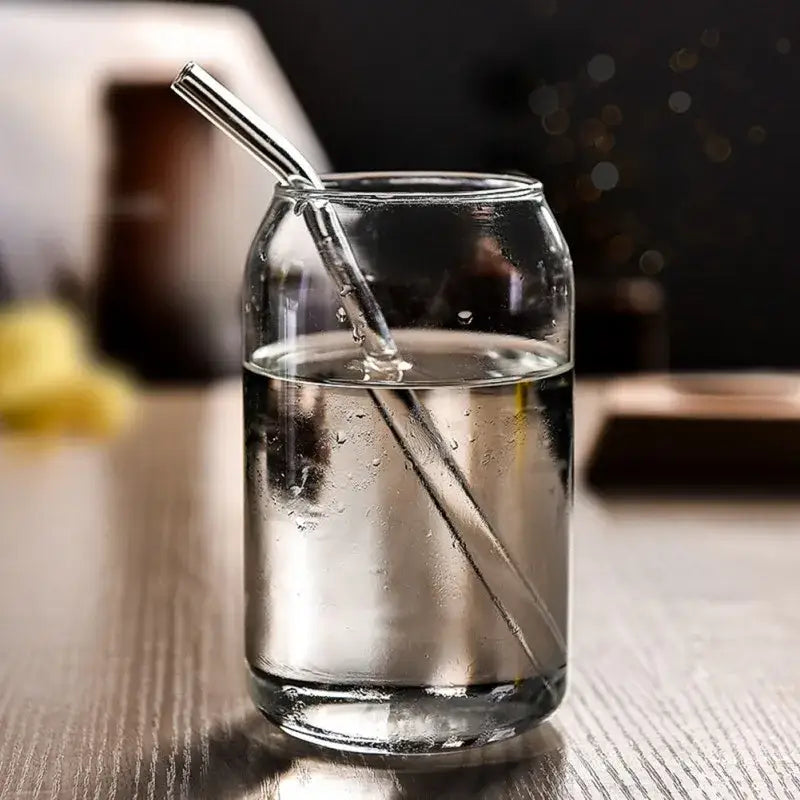 Clear glass large shape beer glass cup with metallic straw for dining room use in a sleek cylindrical design