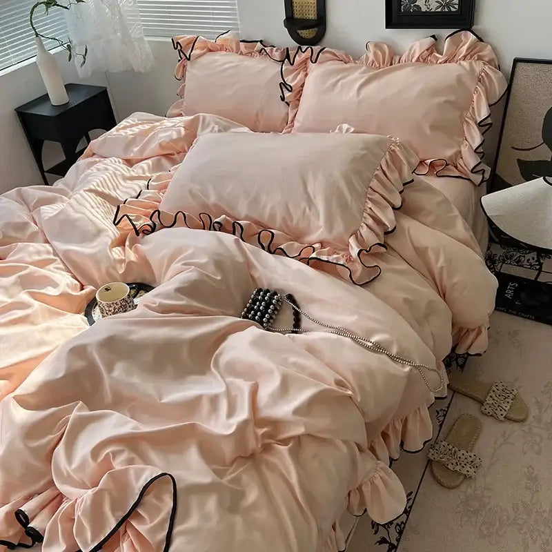 A soft blush pink satin bedding set with delicate black ruffled trim from decorbites cooling silky ruffled collection
